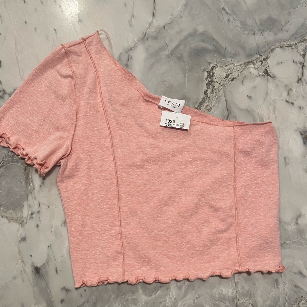 Orange top one sleeved. Size small.
